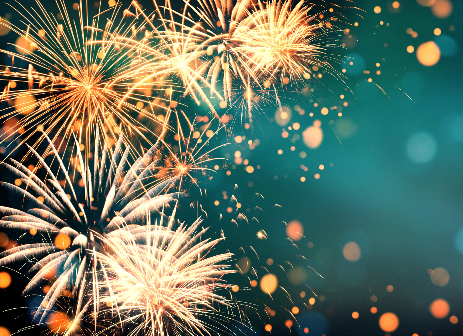 Bright golden fireworks explode against a teal and turquoise night sky, with sparkling light bokeh effects scattered throughout the image, creating a festive and celebratory atmosphere.
