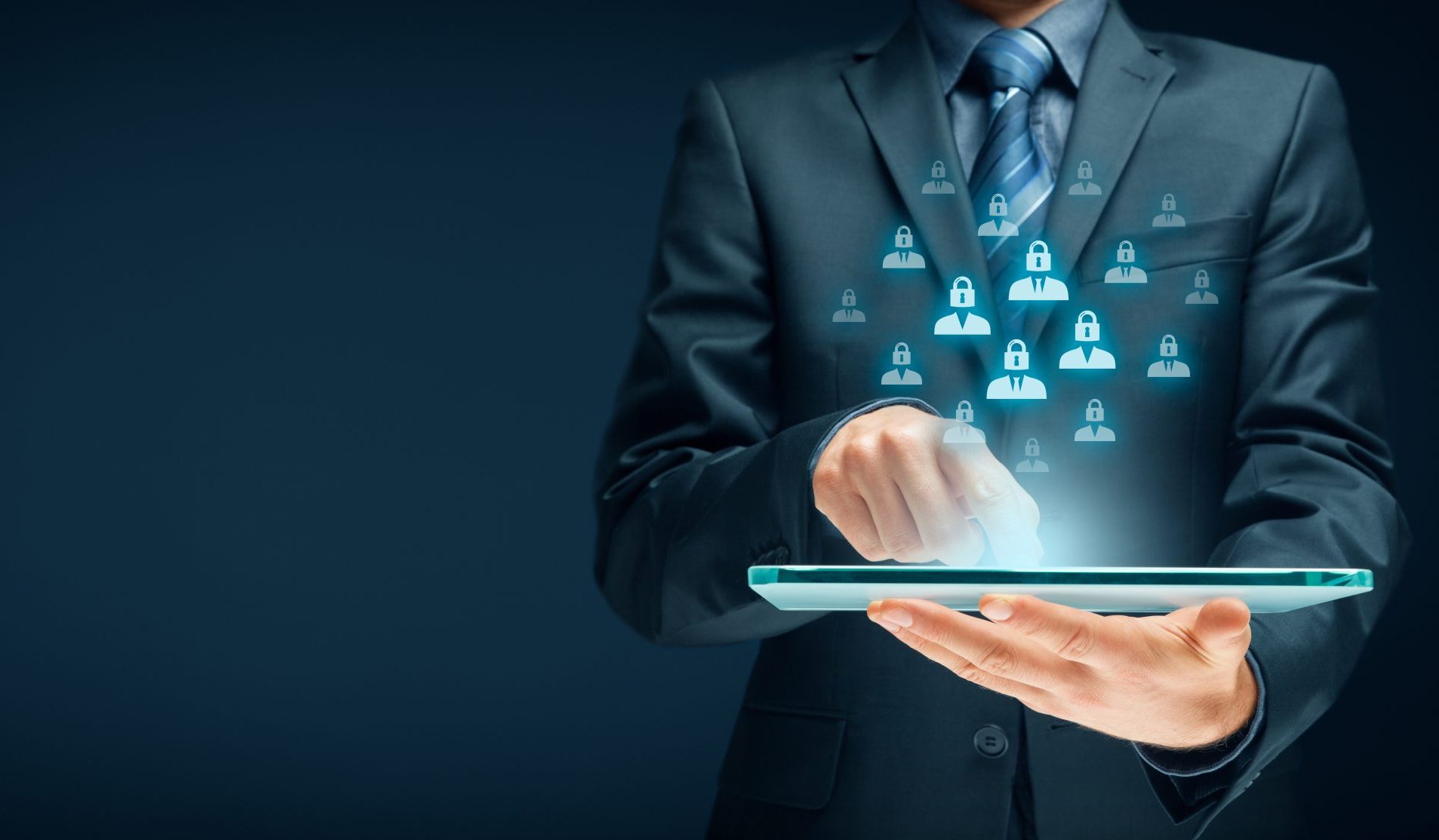 A man in a suit uses a tablet, with digital icons of user profiles and padlocks floating above the screen, symbolizing cybersecurity and data protection.